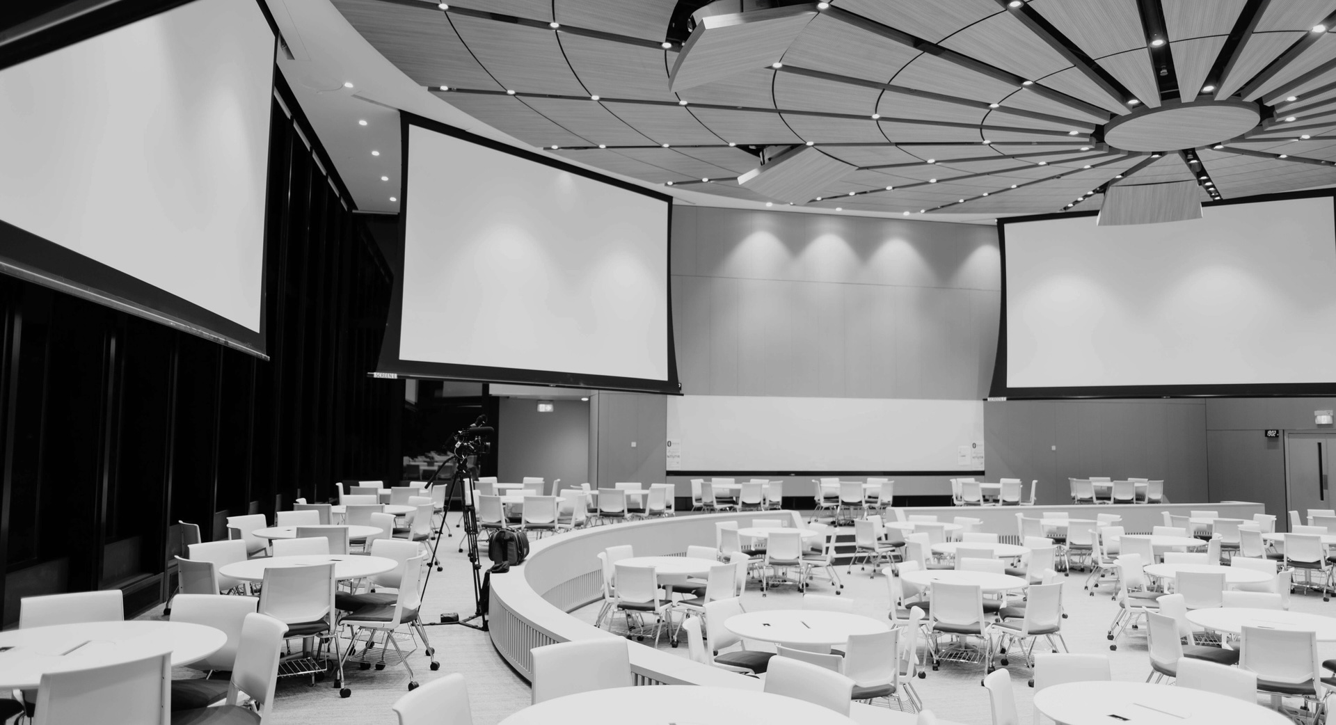 IFHRS events visual: black and white conference hall with large screens